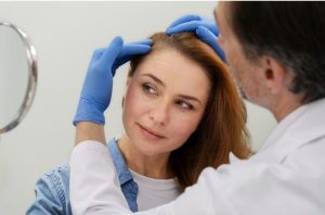 Woman getting a hair loss treatment at a clinic